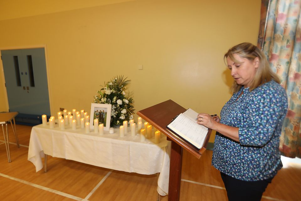 Sonya Smith leaves a message in the  book of condolence which was opened at the school James and Sara previously attended
